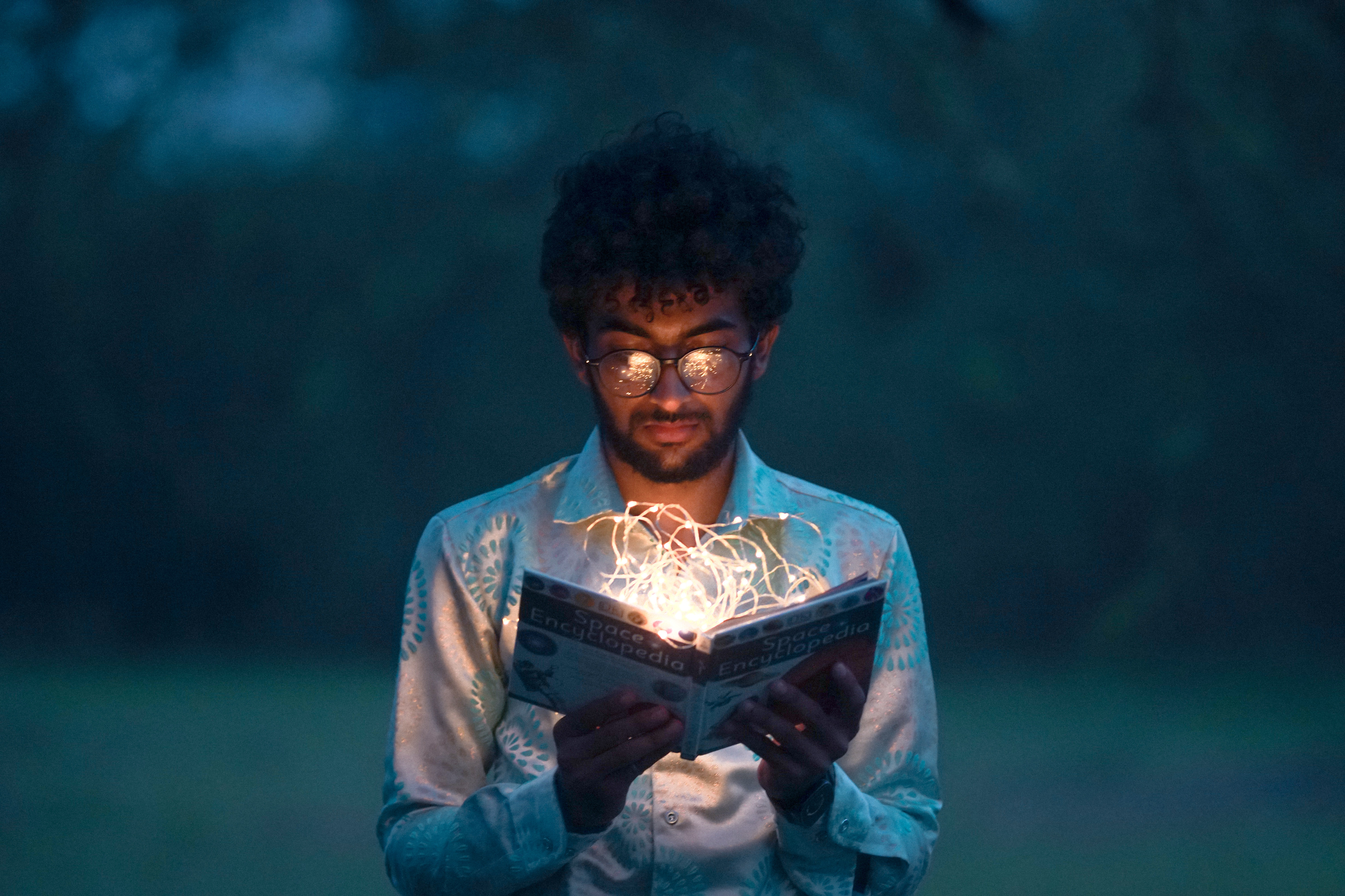 Man opens book which emits light